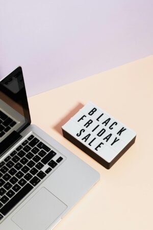 Minimalist laptop scene with black friday sale sign, perfect for retail marketing visuals.